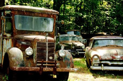 Old abandoned car on field