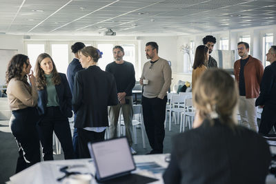 Group of business people talking during conference break