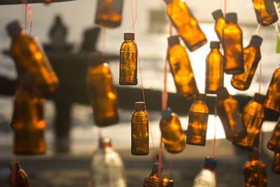 Brown bottles hanging outdoors on sunny day