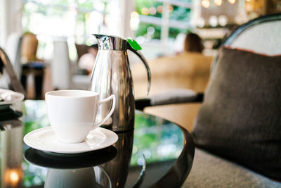 English afternoon tea set including the teapot and a tea cup on white plate.