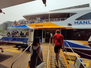 Group of people walking on road along buildings