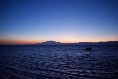 Scenic view of sea and etna volcano against clear sky during sunset.