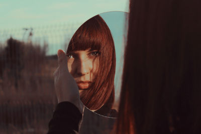 Close-up of woman holding mirror