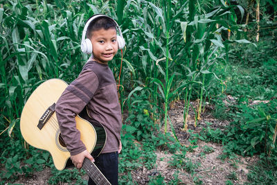 Portrait of smiling girl standing against plants