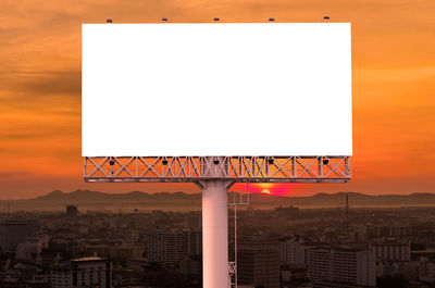 Information sign against clear sky during sunset