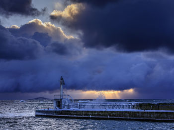 Scenic view of sea against storm clouds