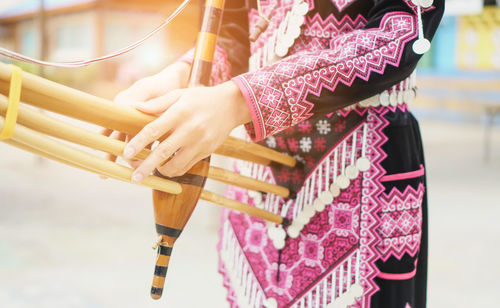 Midsection of woman holding umbrella