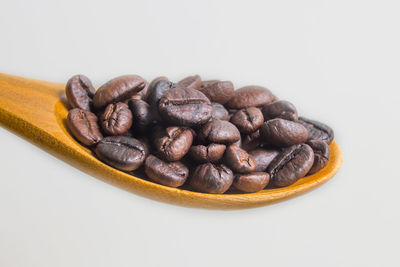 Close-up of coffee beans against white background