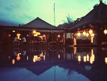 Reflection of built structures in water at dusk