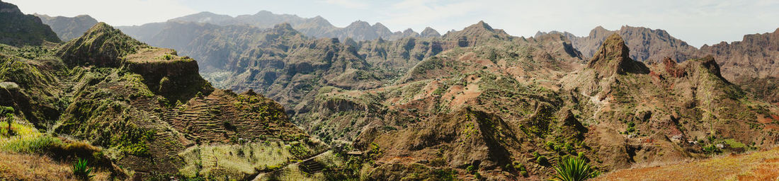 Panoramic view of trees and mountains against sky