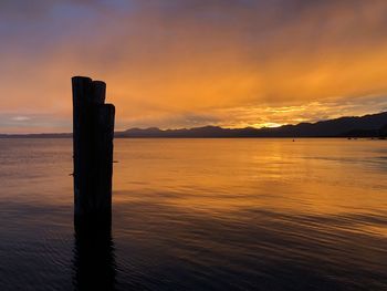 Scenic view of lake against sky during sunset