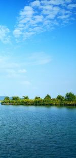 Scenic view of lake against blue sky