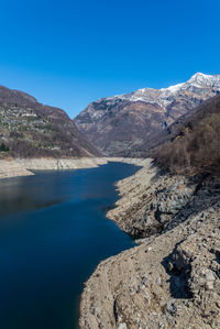 Scenic view of mountains against clear blue sky