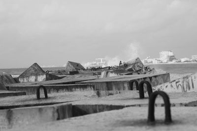 Old abandoned building on field against sky