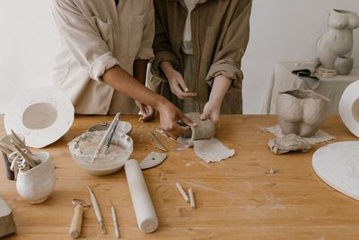 Midsection of woman preparing food on table