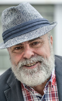 Close-up portrait of mature man wearing hat