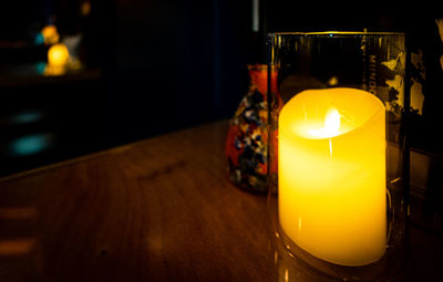 Close-up of illuminated tea light candles on table