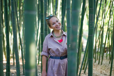 Portrait of smiling young woman standing on field