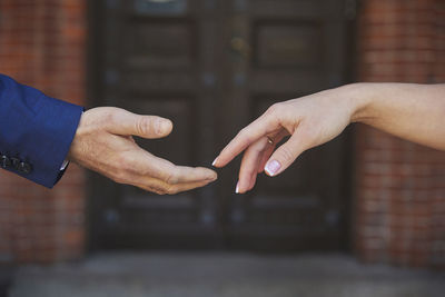 Cropped hand of man using mobile phone