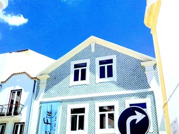 Low angle view of building against blue sky