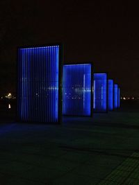 Illuminated lights against blue sky at night