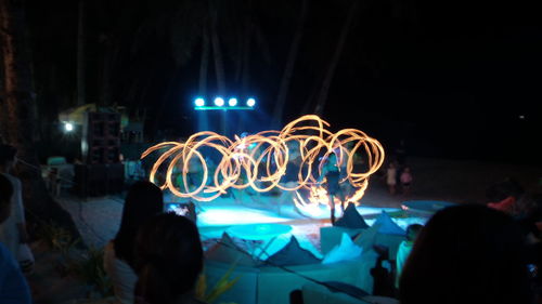 People watching light trails at night