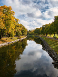 Scenic view of lake by trees against sky