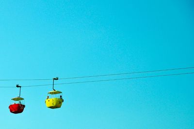 Low angle view of cables against clear blue sky