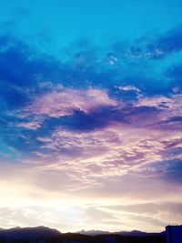 Low angle view of cloudy sky at sunset