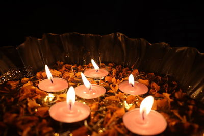 Close-up of burning candles in temple