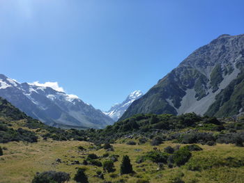 Scenic view of mountains against clear blue sky