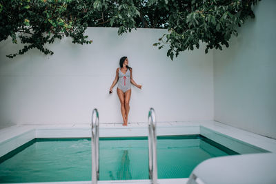 High angle view of woman relaxing in swimming pool