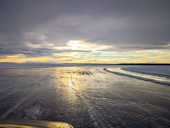 Scenic view of beach against sky during sunset