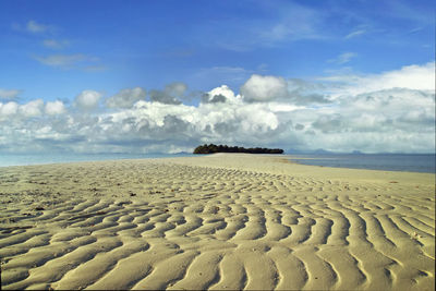 Scenic view of beach against blue sky