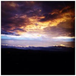 Scenic view of mountains against cloudy sky