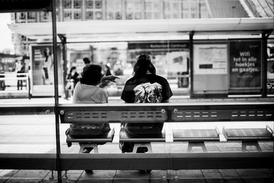 People sitting on railroad station platform