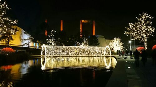 Reflection of illuminated buildings in water at night