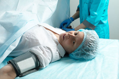 High angle view of woman lying on bed