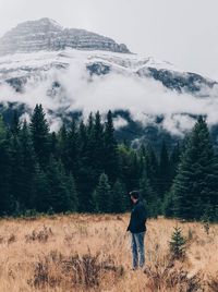 Portrait of man standing on mountain against sky