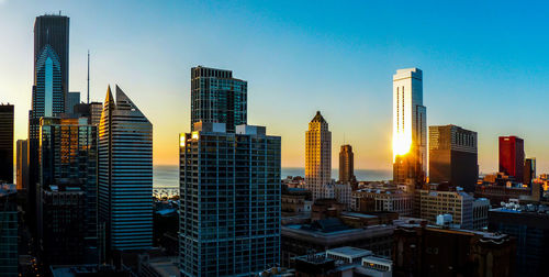 A view of the chicago skyline over lake michigan at sunrise