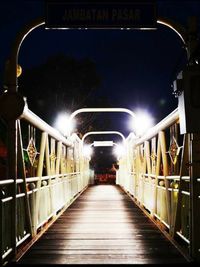 Illuminated tunnel at night