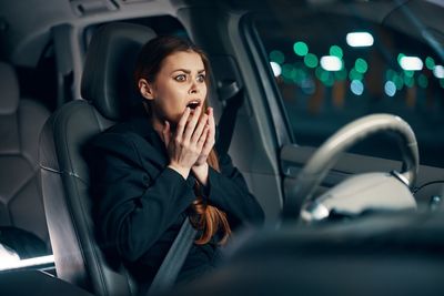 Woman screaming sitting in car