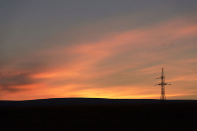 Silhouette landscape against sky during sunset