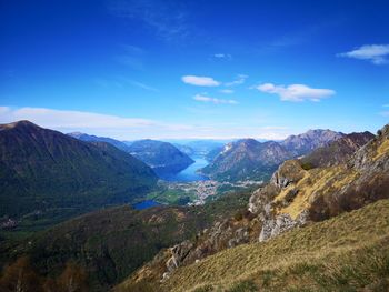 Scenic view of landscape and mountains against blue sky