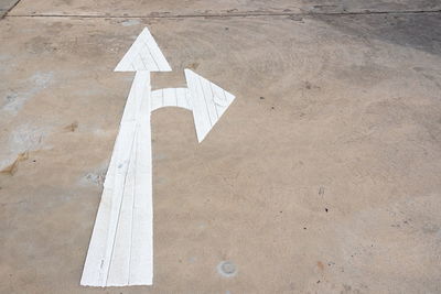 High angle view of arrow symbol on road