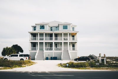 Building by road against sky