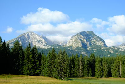 Scenic view of mountains against cloudy sky