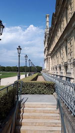 Footpath leading towards building against sky