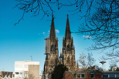 Church in city against blue sky