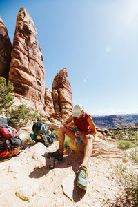 Female hiker takes a water break in the hot desert midday sun